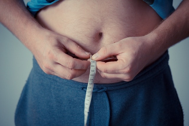homem com obesidade medindo a circunferência
