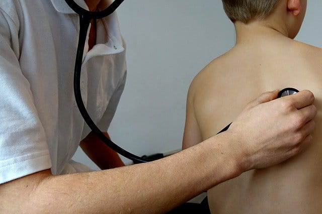 Médico verifica respiração de criança na fase inicial da Covid-19 para depois verificar a necessidade de ventialçaõ mecânica caso os sintomas piorem
